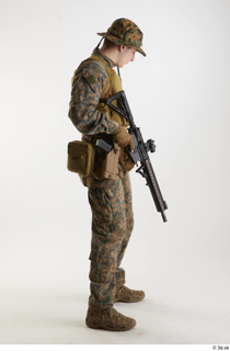 Casey Schneider in WDL Marpat Pose 5 loading gun standing…